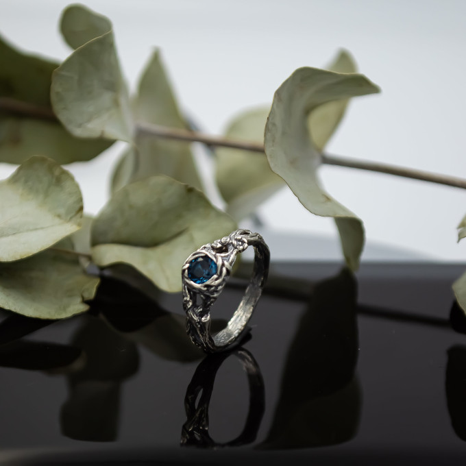 Wings of Serenity: Gothic Sterling Silver Ring with Blue Topaz