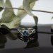 Wings of Serenity: Gothic Sterling Silver Ring with Blue Topaz