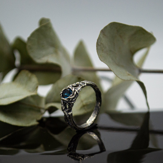 Wings of Serenity: Gothic Sterling Silver Ring with Blue Topaz
