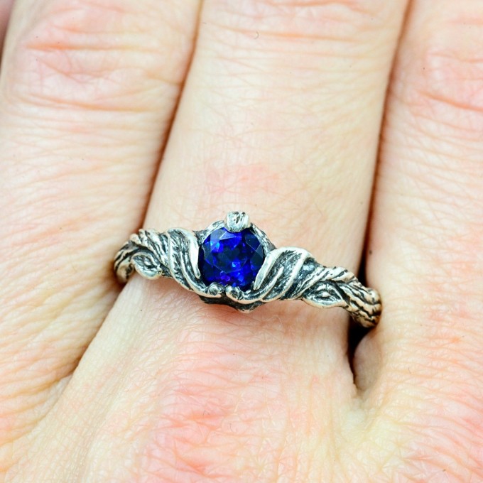 Delicate Silver Band Featuring a Blue Sapphire Gemstone