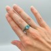 Elegant Silver Ring with Twisting Vines and Emerald Gemstone