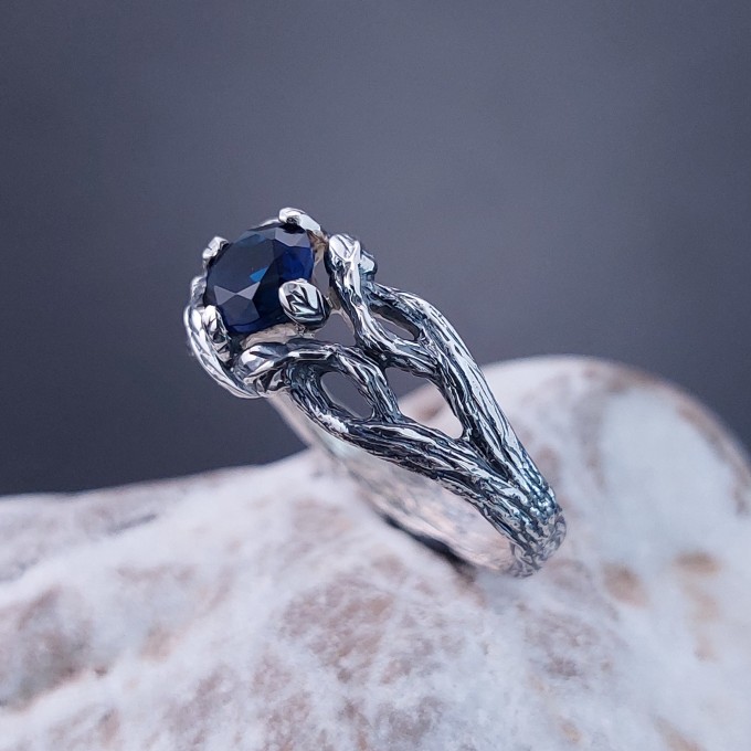 Intricate Silver Ring with Sapphire and Nature Motif