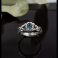 Wings of Serenity: Gothic Sterling Silver Ring with Blue Topaz