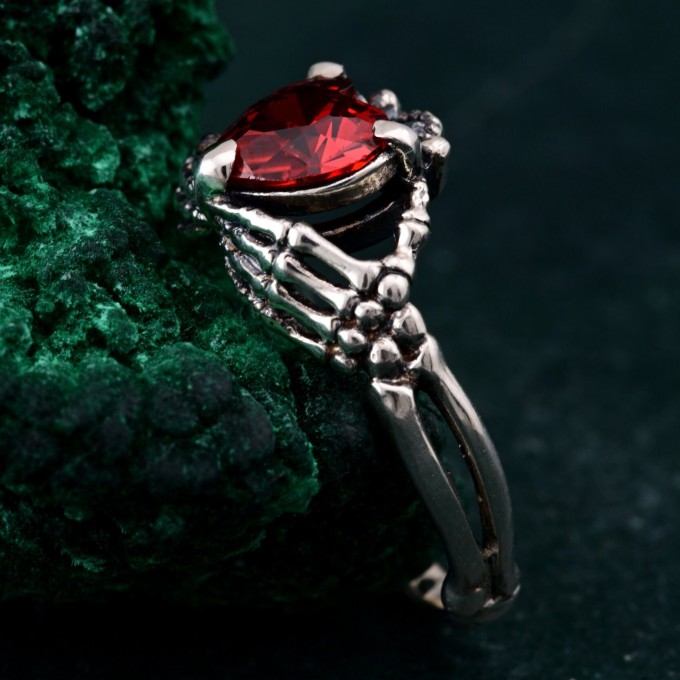 Embrace of Shadows: Gothic Skeleton Hand Garnet Ring