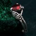 Embrace of Shadows: Gothic Skeleton Hand Garnet Ring