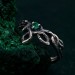Discover the Emerald Celtic Style Wedding Band featuring a wood bark branch weave. This rustic and unique ring is perfect for those seeking a nature-inspired and distinctive wedding band.