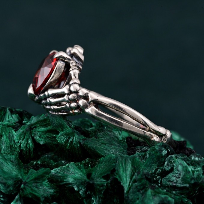Embrace of Shadows: Gothic Skeleton Hand Garnet Ring