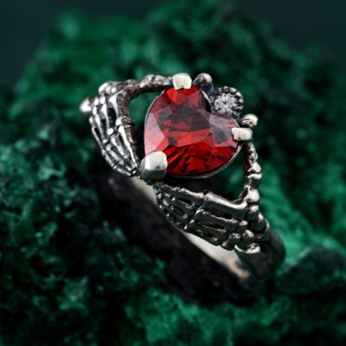 Embrace of Shadows: Gothic Skeleton Hand Garnet Ring
