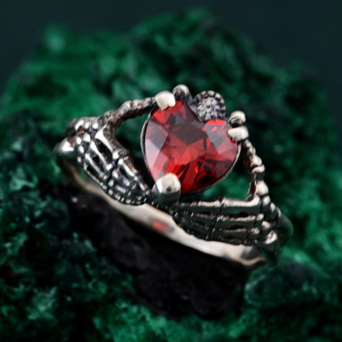 Embrace of Shadows: Gothic Skeleton Hand Garnet Ring